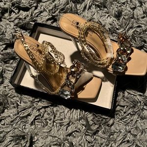 Sexy clear nude pump with ankle buckle and rhinestone toe strap.